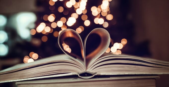 Paper book in the shape of a heart on a bokeh background. valentine's day. love symbol