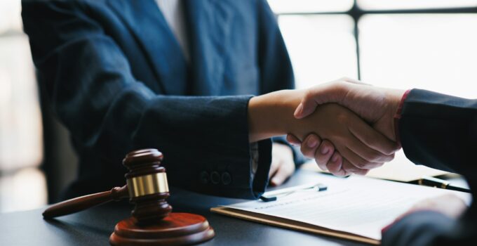 Lawyers shake hands with business people to seal a deal with partner lawyers. or a lawyer discussing