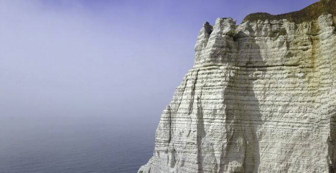 Top view of white cliff with arch. Action. Arched passage in white cliff - beautiful miracle of